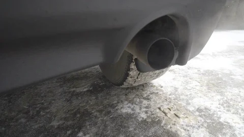 Toxic gases are exhausted on the tailpipe of a car, polluting the atmosphere. Stock Footage