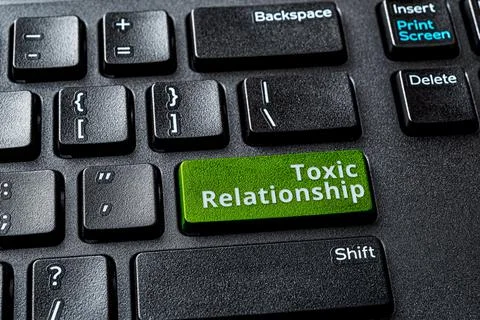 Toxic relationship words on the enter key of a desktop computer keyboard. Stock Photos