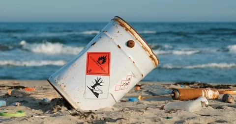 Toxic rusty barrel. Spilled trash beach city. Empty used dirty plastic bottles Stock Footage 126522574