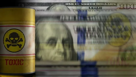 Toxic warning barrels over Dollars money banknotes Stock Footage 315097675