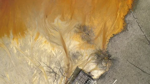 Toxic waste lake from a mining exploitation on the place of a former village and Stock Footage 106528929