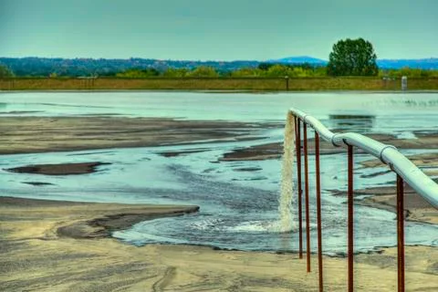 Toxic water stems from the pipe polluting the lake Stock Photos