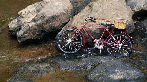 Toy bicycle on water background, Stock-Footage 73755178
