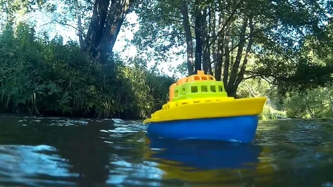 Toy boat on the river Stock Footage 79601898