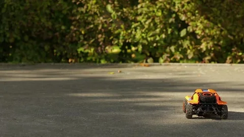 A toy buggy controlled by a remote control. Amewi Knight Dune Buggy 4WD. Stock-Footage 346205658