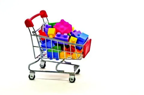 Toy building construction block bricks for kids in a shopping cart isolated o Stock Photos