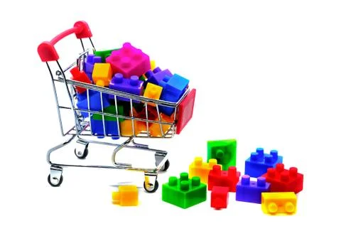 Toy building construction block bricks for kids in a shopping cart isolated o Stock Photos