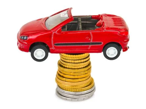 Toy car and stack of coins 스톡 사진