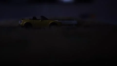 Toy car on the side of the road with lighting strikes flashing Vidéo 275858734