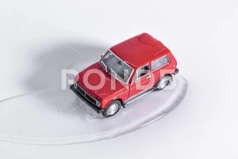 Toy car thaws from ice. defrosting retro toy SUV. close-up on a white background Stock Photos
