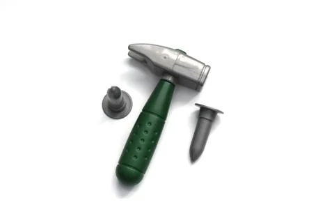 Toy construction tools on a white background. Hammer, wrench, nails and bolt. Stock Photos