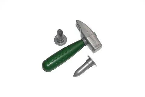 Toy construction tools on a white background. Hammer, wrench, nails and bolt. Stock Photos