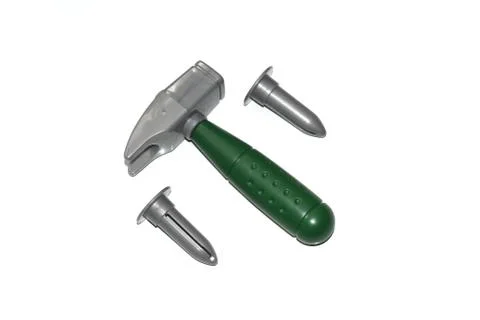 Toy construction tools on a white background. Hammer, wrench, nails and bolt. Stock Photos