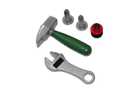 Toy construction tools on a white background. Hammer, wrench, nails and bolt. Stock Photos