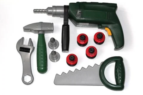 Toy construction tools on a white background. Hammer, wrench, nails and bolt. Stock Photos