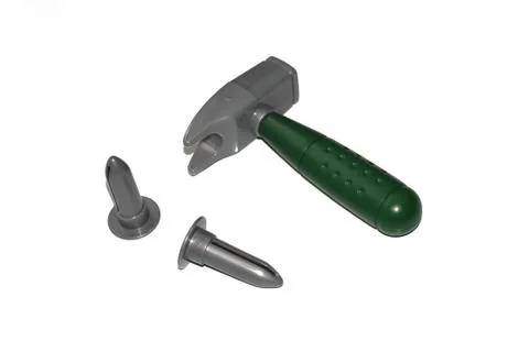 Toy construction tools on a white background. Hammer, wrench, nails and bolt. Stock Photos