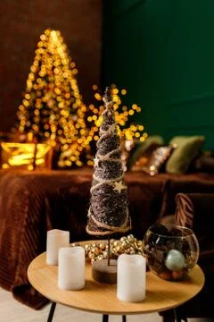 Toy decorative Christmas tree on a table with candles Stock Photos