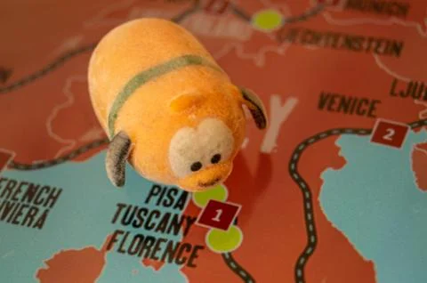 Toy dog is looking for a path on the map. Travel themed abstraction. Stock Photos