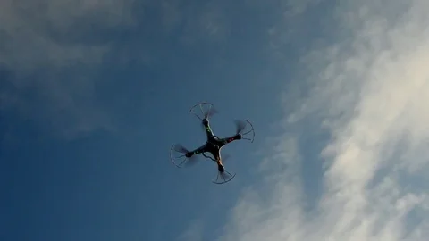 Toy drone with camera fighting with the wind above trees. 스톡 동영상 84819731
