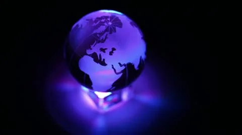 Toy Earth sphere stand on cube with color illumination, composition spins Stock Footage 10852615