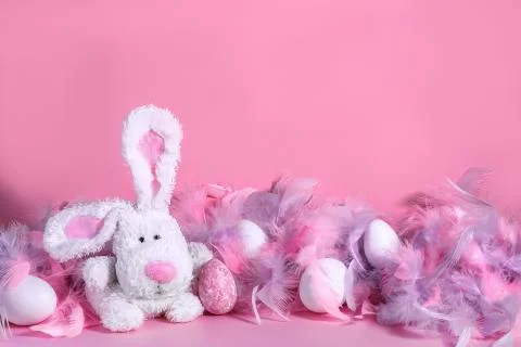 Toy Easter bunny rabbit with soft and gentle pink and violet feathers boa and Stock Photos