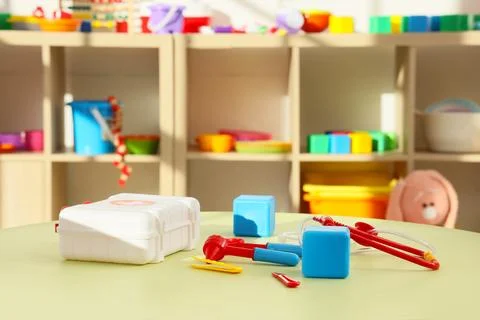 Toy first aid kit on table in kindergarten Stock Photos