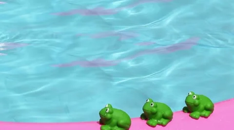 Toy frog on an inflatable pool Stock Footage 7905982