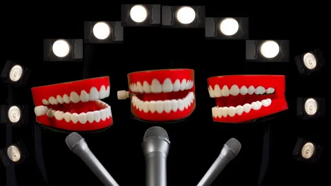 Toy joke chatty teeth trio with microphones and spot lights. Stage performance. Stock Footage 240740533