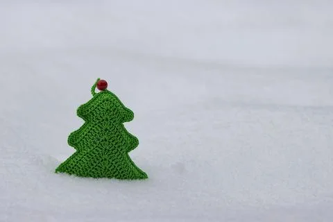 A toy made of green threads in the shape of a Christmas tree. Stock Photos