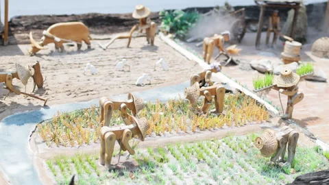Toy mechanical figures working in field. Stock Footage 306849433