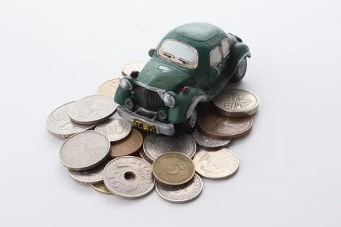 Toy model car with stack of coins Stock Photos