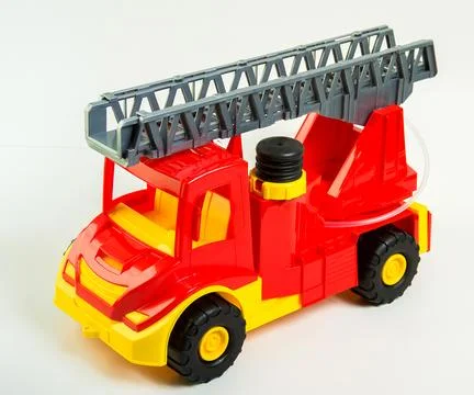 Toy multi-colored plastic fire truck on a white background. Foto stock