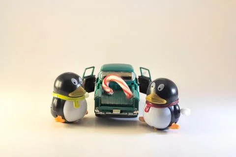 Toy Penguins Loading Candy Cane onto Toy Truck Stock Photos