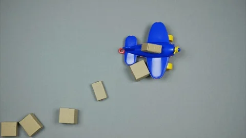 Toy plane dropping parcels down. International Parcels delivery. Stock Footage 103229876