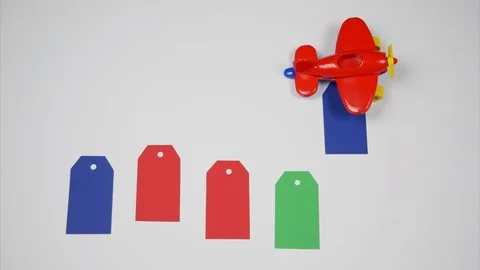 Toy plane throws blank price tags. Stop motion animation Stock Footage 103219664