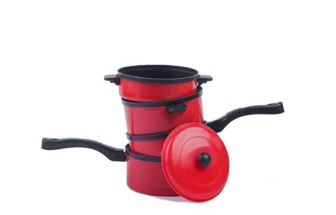 Toy plastic stack of pans isolated on a white background. Kid's Kitchen 库存照片