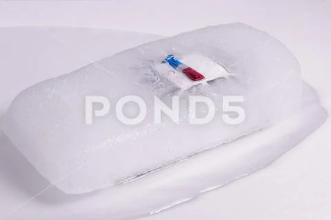 Toy police car thawing from ice. frozen police car Stock Photos