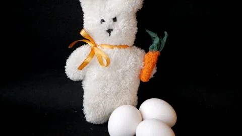 Toy rabbit and three eggs Stock Footage 151692308