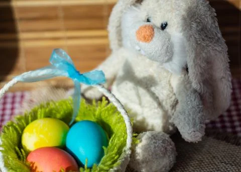Toy rabbit with a basket of Easter eggs. 写真素材
