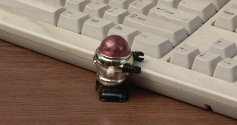 Toy Robot - Wind Up - On Desk by Keyboard Stock Footage 164929983