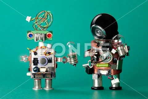 Toy robots with lamp bulbs. Circuits chip handyman characters, funny black Stock Photos