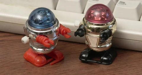 Toy Robots - Wind Up - On Desk by Keyboard Stock Footage 164929953