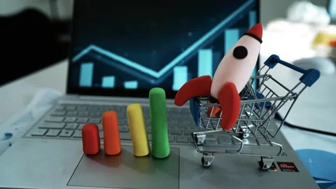 Toy Rocket and Bar Graph on Laptop Symbolizing Business Growth, A toy rocke.. Stock Footage 304879440