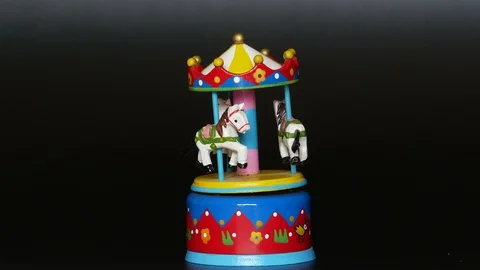 Toy rotating carousel with three white horses horse  music box Stock Footage 129190174