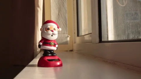 Toy Santa claus dancing on window ledge Stock Footage 143707164