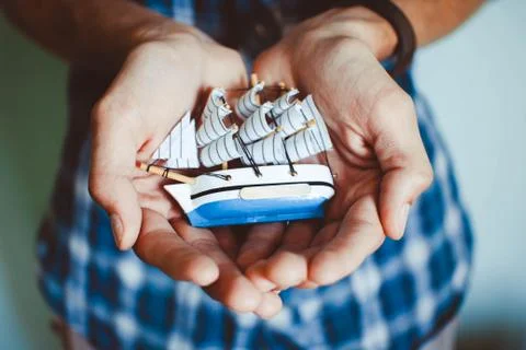 Toy ship in hands Stock Photos
