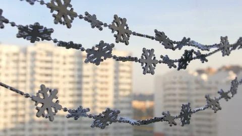 Toy snowflakes waving in the wind, a cold day. conveys an exciting mood. Stock Footage 82603938