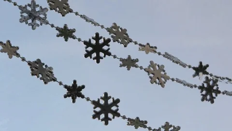Toy snowflakes waving in the wind, a cold day. conveys an exciting mood. Stock Footage 82604227