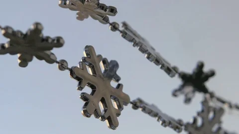 Toy snowflakes waving in the wind, a cold day. conveys an exciting mood. Stock Footage 82605009
