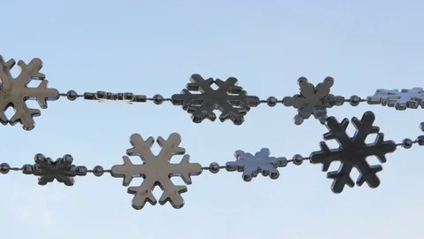 Toy snowflakes waving in the wind, a cold day. conveys an exciting mood. Stock Footage 82605086